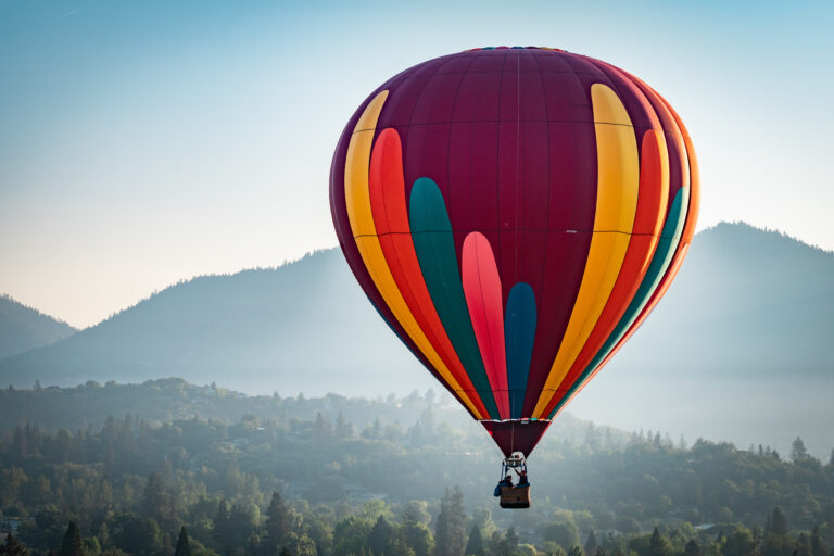 Colorful hot air balloon over Grants Pass Oregon on a beautiful summer morning